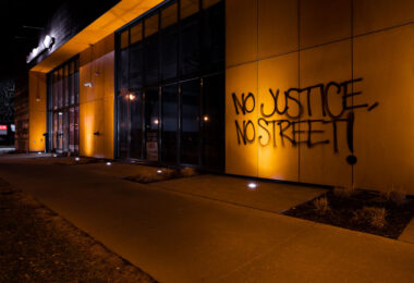 "No Justice, No Strteet!" written on the side of building in Uptown Minneapolis. It refers to George Floyd Square where the city has had press conferences the last 2 days about opening the intersection back up to vehicular traffic. The intersection has been closed since George Floyd's May 25th death and been held by the community as a place of protest and sacred ground.