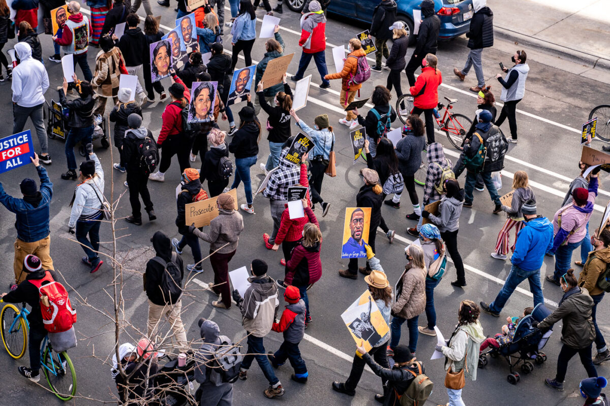 Protesters march through downtown Minneapolis the day before the Derek Chauvin murder trial opening statements.