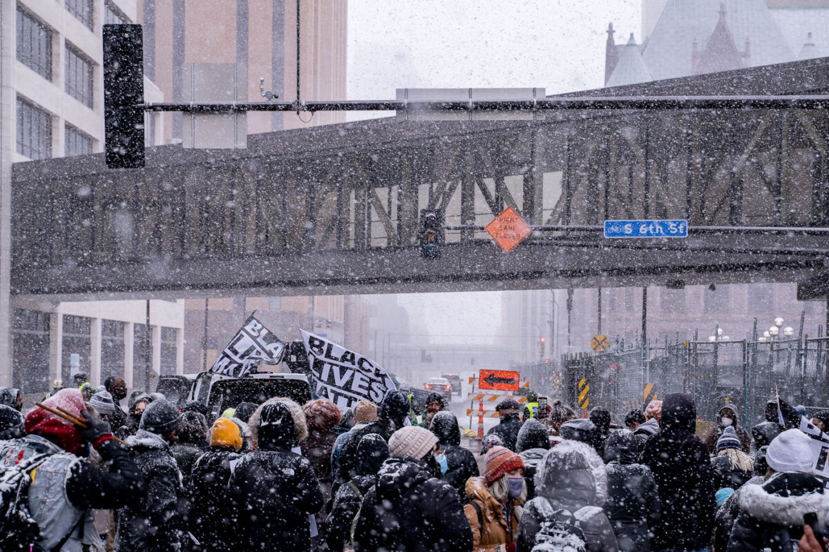 Protesters march around the Hennepin County Government Center demanding a fair jury selection process in the Derek Chauvin trial.