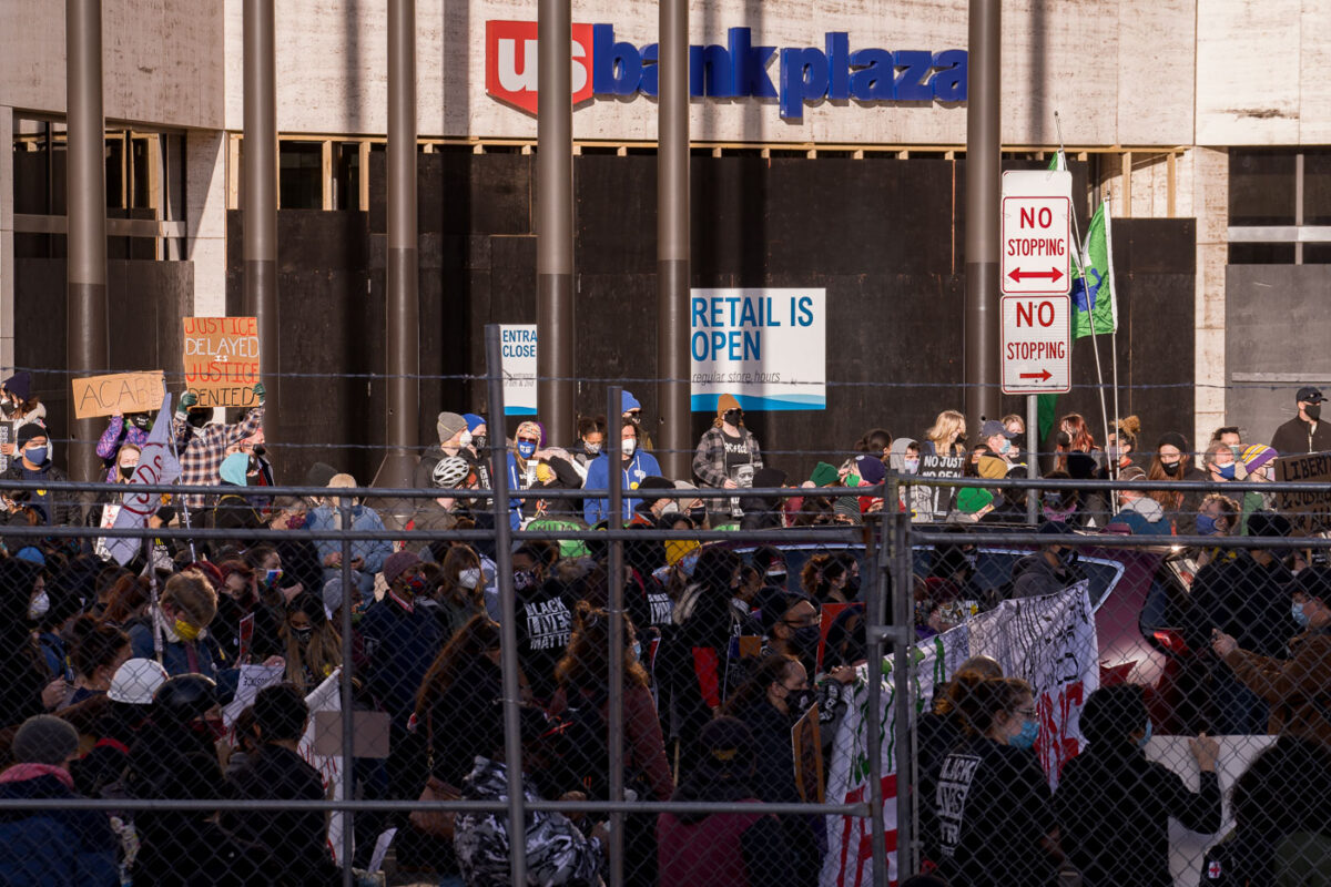 Protesters behind security fencing that surrounds the courthouse where the Derek Chauvin murder trial is taking place.