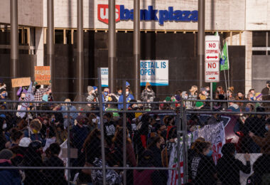 Protesters behind security fencing that surrounds the courthouse where the Derek Chauvin murder trial is taking place.