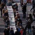 The day before Derek Chauvin goes on trial in Minneapolis for the murder of George Floyd a thousand march from the Government Center and down Hennepin Ave with a scroll that has 470+ names of people killed by MN police. Organizers point out Chauvin was involved in 5 of the names.