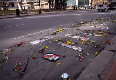Protesters place mirrors and red paint on the road outside the courthouse.