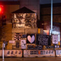 Protest signs hang on the former Minneapolis Police Third Precinct. The precinct was burned during unrest over the May 25th death of George Floyd.