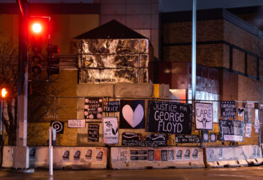 Protest signs hang on the former Minneapolis Police Third Precinct. The precinct was burned during unrest over the May 25th death of George Floyd.