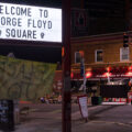 The former Speedway Gas sign reads "Welcome to George Floyd Square".