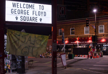 The former Speedway Gas sign reads "Welcome to George Floyd Square".