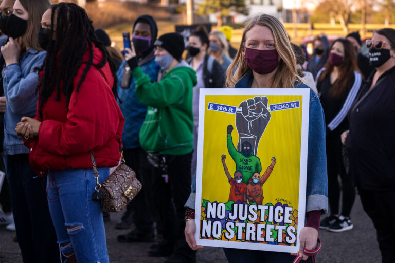 Woman holds up No Justice No Streets sign in St Paul 2 Protesters march demanding justice for George Floyd and all those who are victims of police violence.