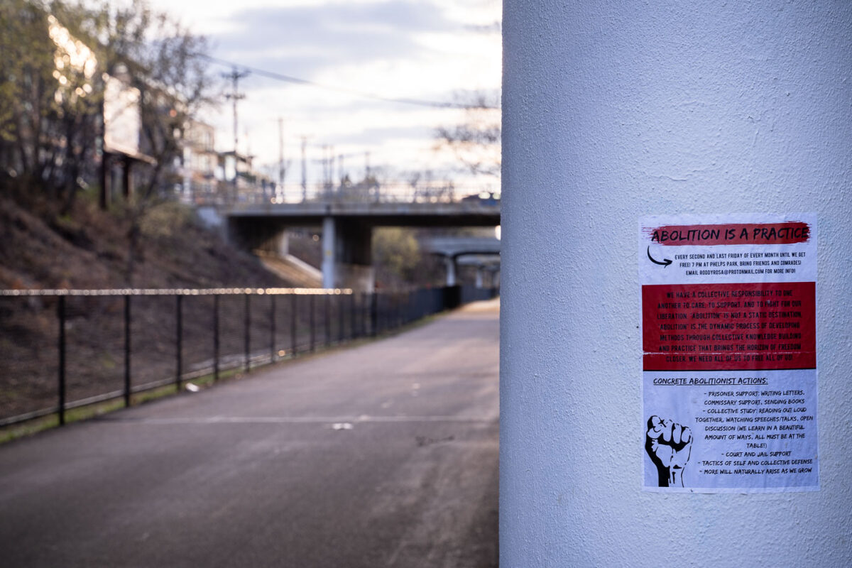 A police abolition sign pasted under a bridge on the Minneapolis Midtown Greenway.