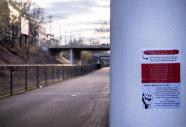 A police abolition sign pasted under a bridge on the Minneapolis Midtown Greenway.