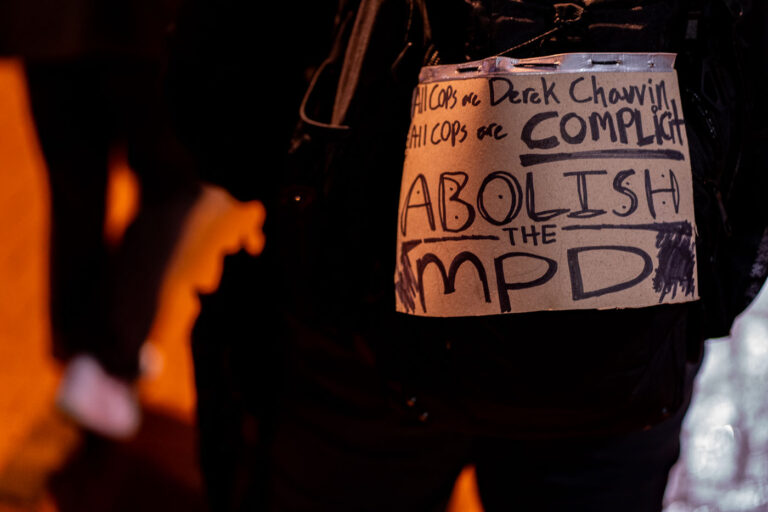 All Cops are Derek Chauvin Abolish the MPD 1 Abolish the MPD protest sign on someones back during a march through downtown Minneapolis.