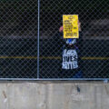 A protester holds up a sign outside the Hennepin County Government Center asking for murder charges against Kim Potter.