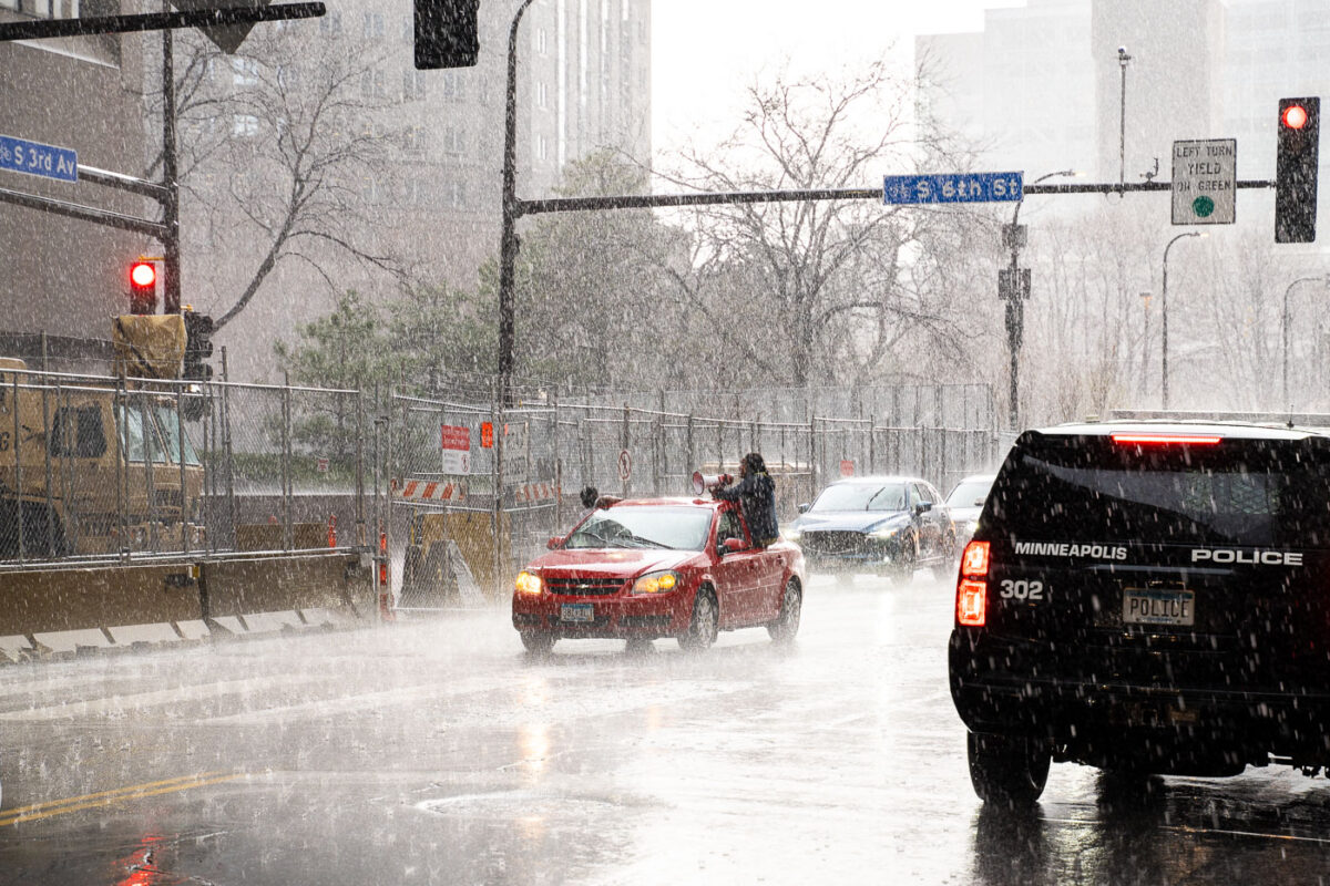 Protesters arrive in a car caravan around the Hennepin County Government Center in the pouring rain. The courthouse is currently holding the Derek Chauvin murder trial. Chauvin is charged in the May 25th murder of George Floyd in South Minneapolis.