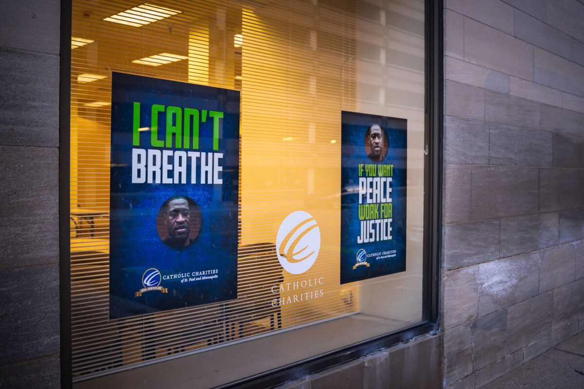 Signs in the windows of Catholic Charities.