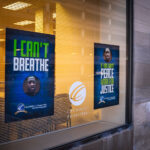 Signs in the windows of Catholic Charities.