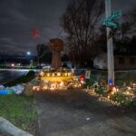 A memorial for Daunte Wright stands where he died. The wooden fist sculpture was the original fist from George Floyd Square.