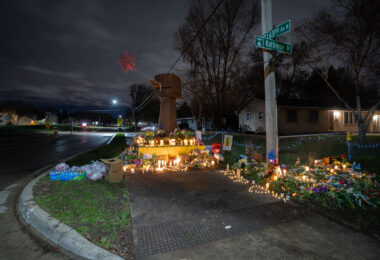 A memorial for Daunte Wright stands where he died. The wooden fist sculpture was the original fist from George Floyd Square.