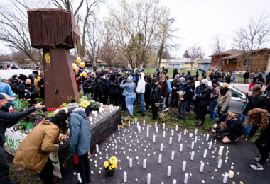 People gather at the site of Daunte Wrights death in Brooklyn Center.