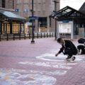 A couple walked by and picked up chalk to help finish a Black Lives Matter mural during the Derek Chauvin murder trial.