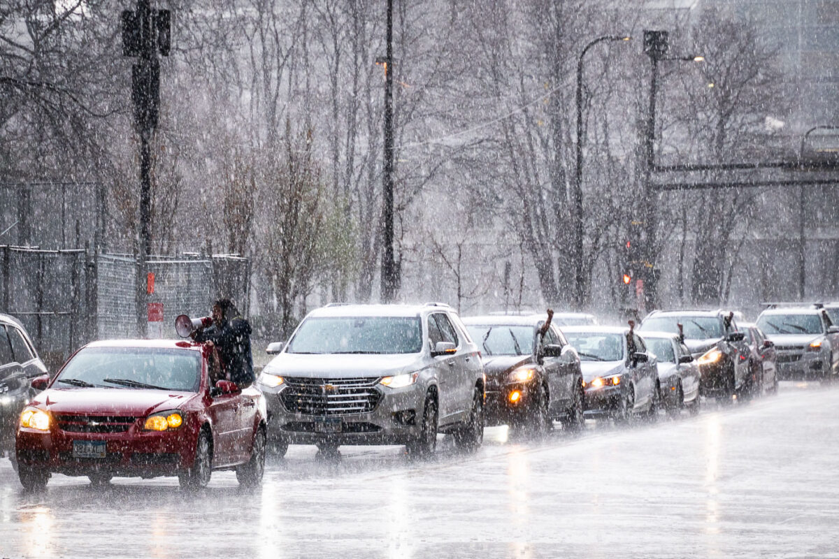 Protesters arrive in a car caravan around the Hennepin County Government Center in the pouring rain. The courthouse is currently holding the Derek Chauvin murder trial. Chauvin is charged in the May 25th murder of George Floyd in South Minneapolis.