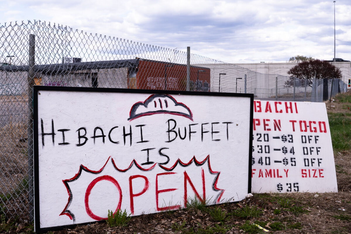 A sign for Hibachi Buffet in front of the burned Lake Street Station post office.