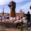 The gardener at George Floyd Square plants flowers and plants around the memorial.