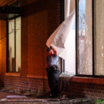 A Minneapolis Police Officer holds open a window for those inside a looted Walgreens to leave on April 11, 2021. Earlier in the day Daunte Wright was killed by Brooklyn Center police officer Kim Potter.