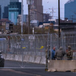 The National Guard stand outside a heavily fortified Minneapolis Police Fifth Precinct.