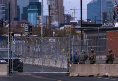 The National Guard stand outside a heavily fortified Minneapolis Police Fifth Precinct.