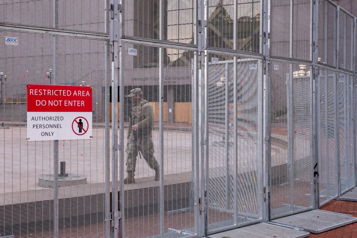 A member of the Minnesota National Guard walks the fencing around the Hennepin County Government Center during the Derek Chauvin murder trial in 2021.