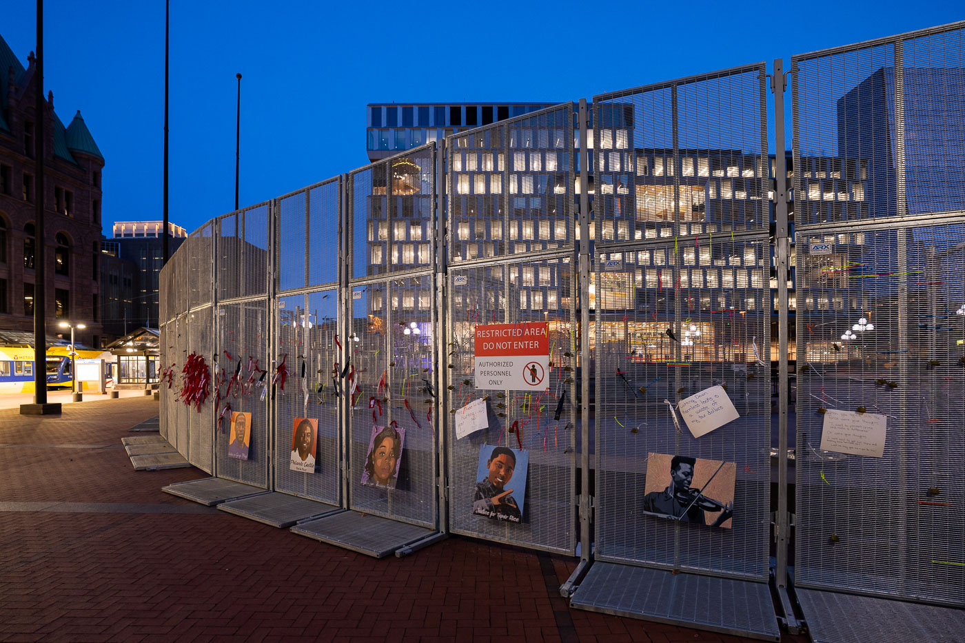 Photos of victims of police violence on courthouse fencing