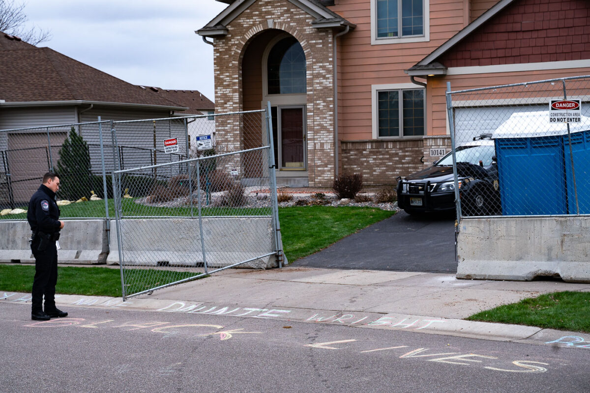 A Champlin police officer reads Daunte Wright chalk outside the home of the officer who shot and killed Wright on April 11th in Brooklyn Center.