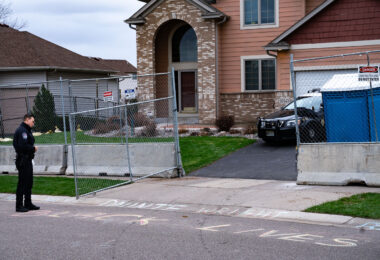 A Champlin police officer reads Daunte Wright chalk outside the home of the officer who shot and killed Wright on April 11th in Brooklyn Center.