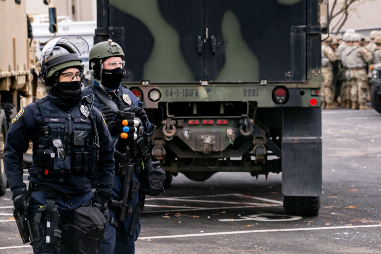 Brooklyn Center Police and National Guard Respond to Protest 3 Law enforcement officers, including the National Guard, are present outside the Brooklyn Center Police Department in Brooklyn Center, Minnesota. This response occurred following the death of Daunte Wright, a 20-year-old man shot by a Brooklyn Park police officer during a traffic stop on April 11th. The incident sparked protests and unrest in the community.