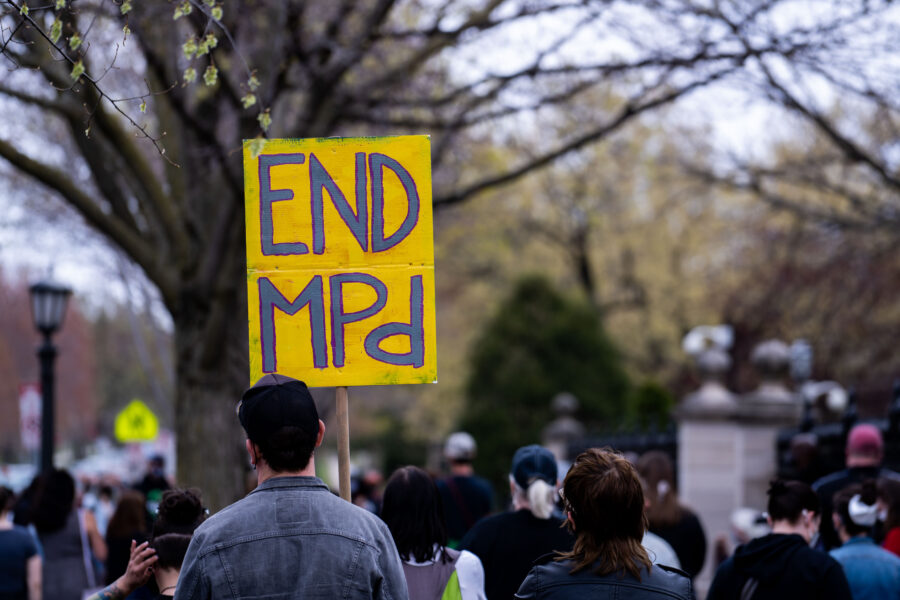 Protester holds END MPD sign at Minnesota Governor’s Residence