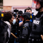 A protester confronts a Brooklyn Center Police Officer following the officer involve shooting death of Daunte Wright.