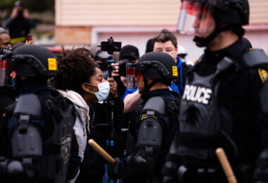 A protester confronts a Brooklyn Center Police Officer following the officer involve shooting death of Daunte Wright.
