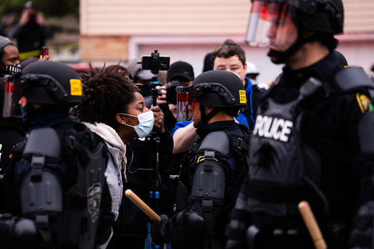 Protesters and police up close with each other 3 A protester confronts a Brooklyn Center Police Officer following the officer involve shooting death of Daunte Wright.
