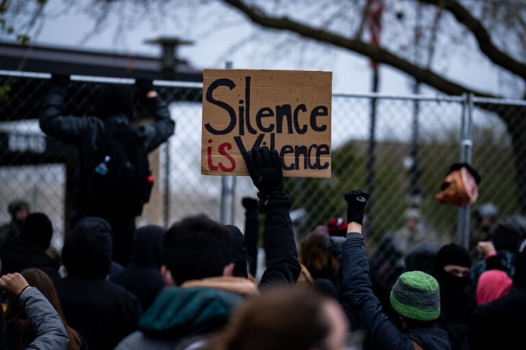 Protesters at the fence in Brooklyn Center 4 Protesters hold up signs outside the Brooklyn Center Police Department after officer Kim Potter shot and killed Daunte Wright.
