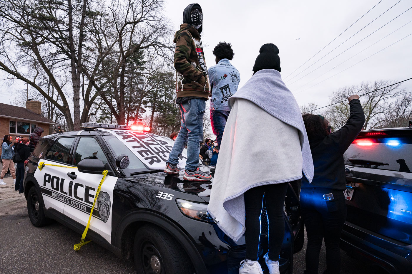 Protesters stand on top of Brooklyn Center squad car