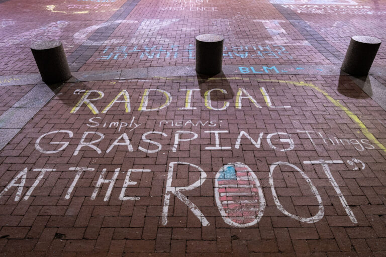Radical Simply Means Grasping Things at the Root 3 Chalk writing on the plaza outside the Hennepin County Government Center. The courthouse is currently holdin the Derek Chauvin murder trial. Chauvin is charged in the May 25th murder of George Floyd in South Minneapolis.