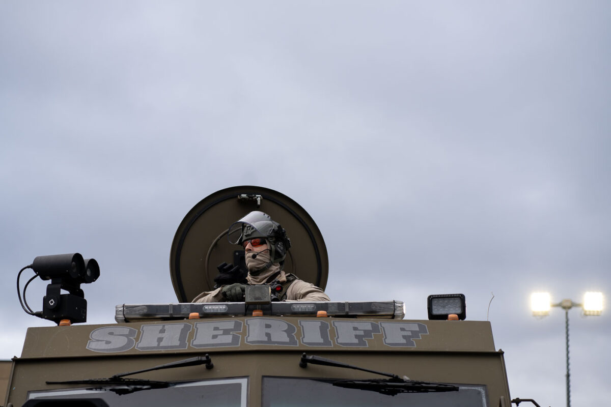 An officer with the Sheriff's department looks out at protesters at the Brooklyn Center Police Department.