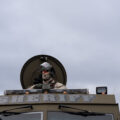 An officer with the Sheriff's department looks out at protesters at the Brooklyn Center Police Department.