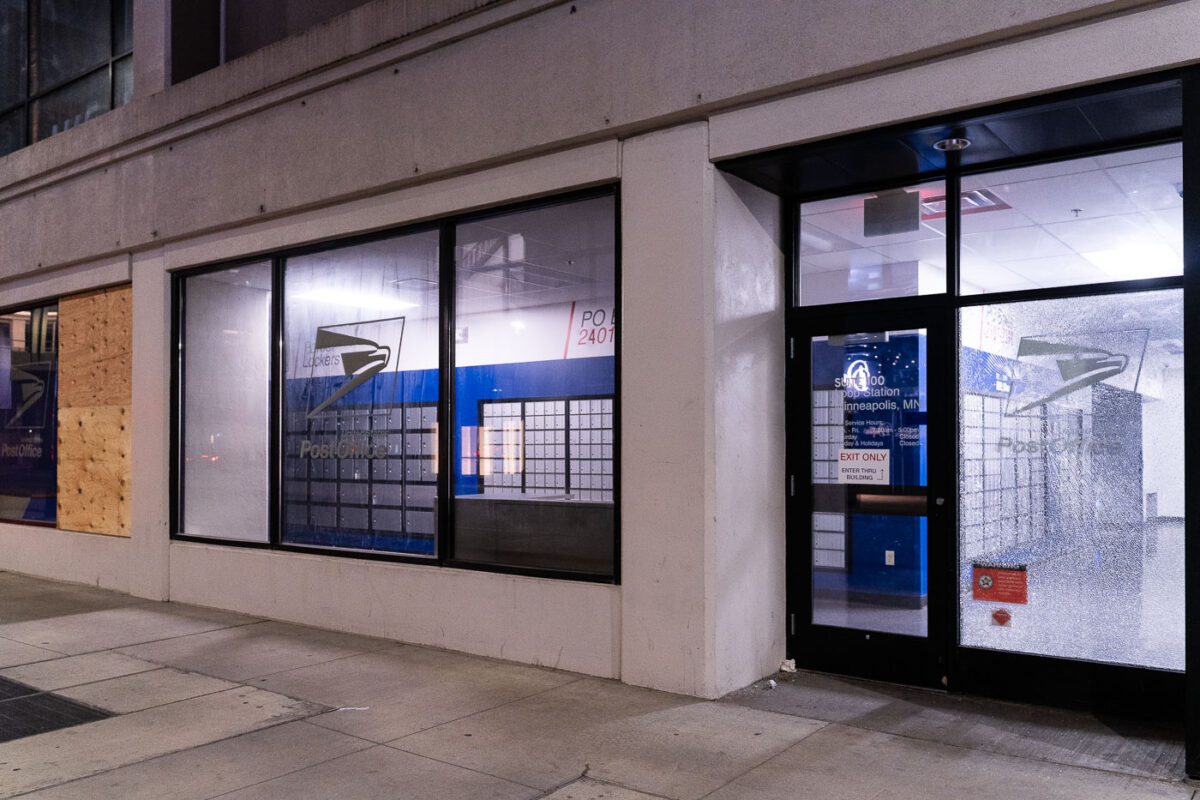 Boarded up and broken windows at the USPS Loop Station in downtown Minneapolis.