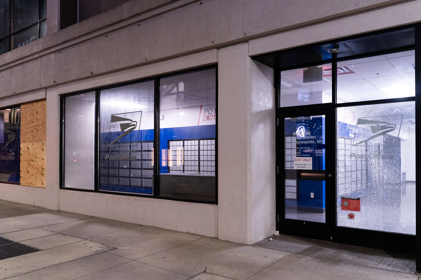 USPS Loop Station boarded up with broken windows