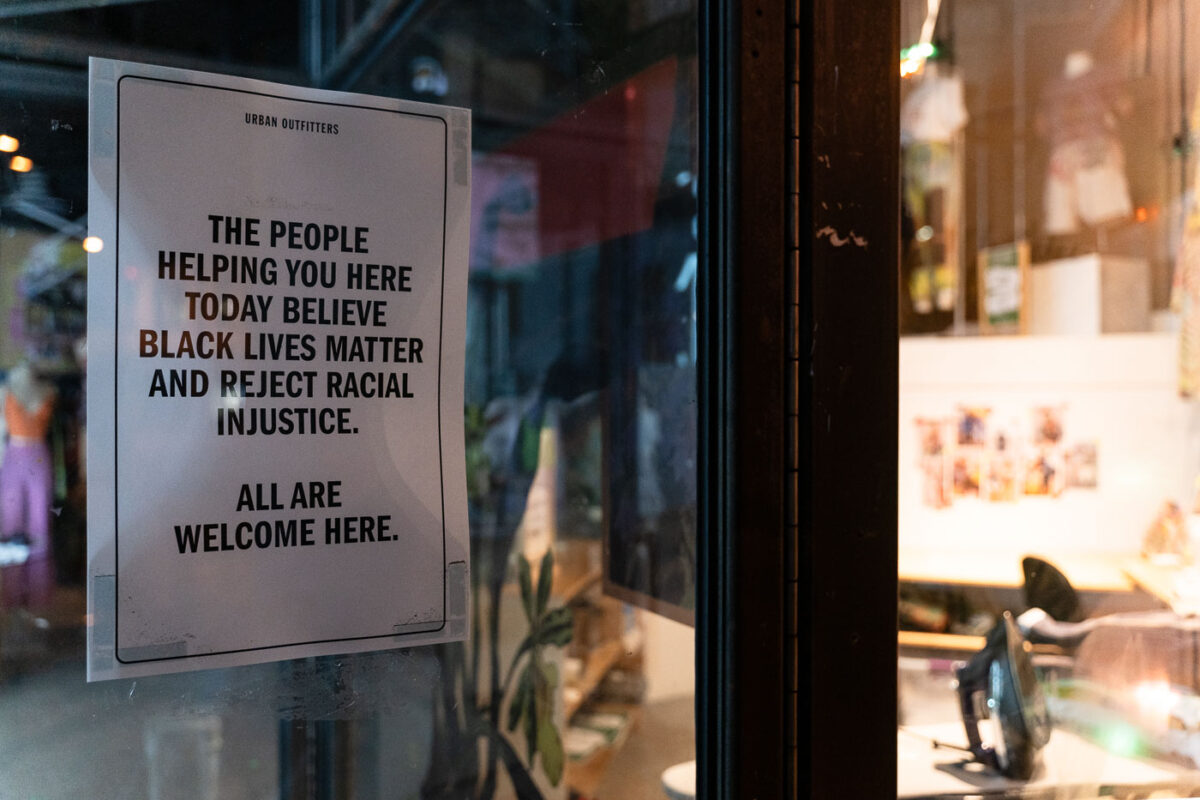 A sign welcoming everyone posted on the front door of Urban Outfitters in Uptown Minneapolis.