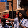 George Floyd’s aunt Angela Harrelson speaks to the crowd at George Floyd Square on the 1-year anniversary of his murder.