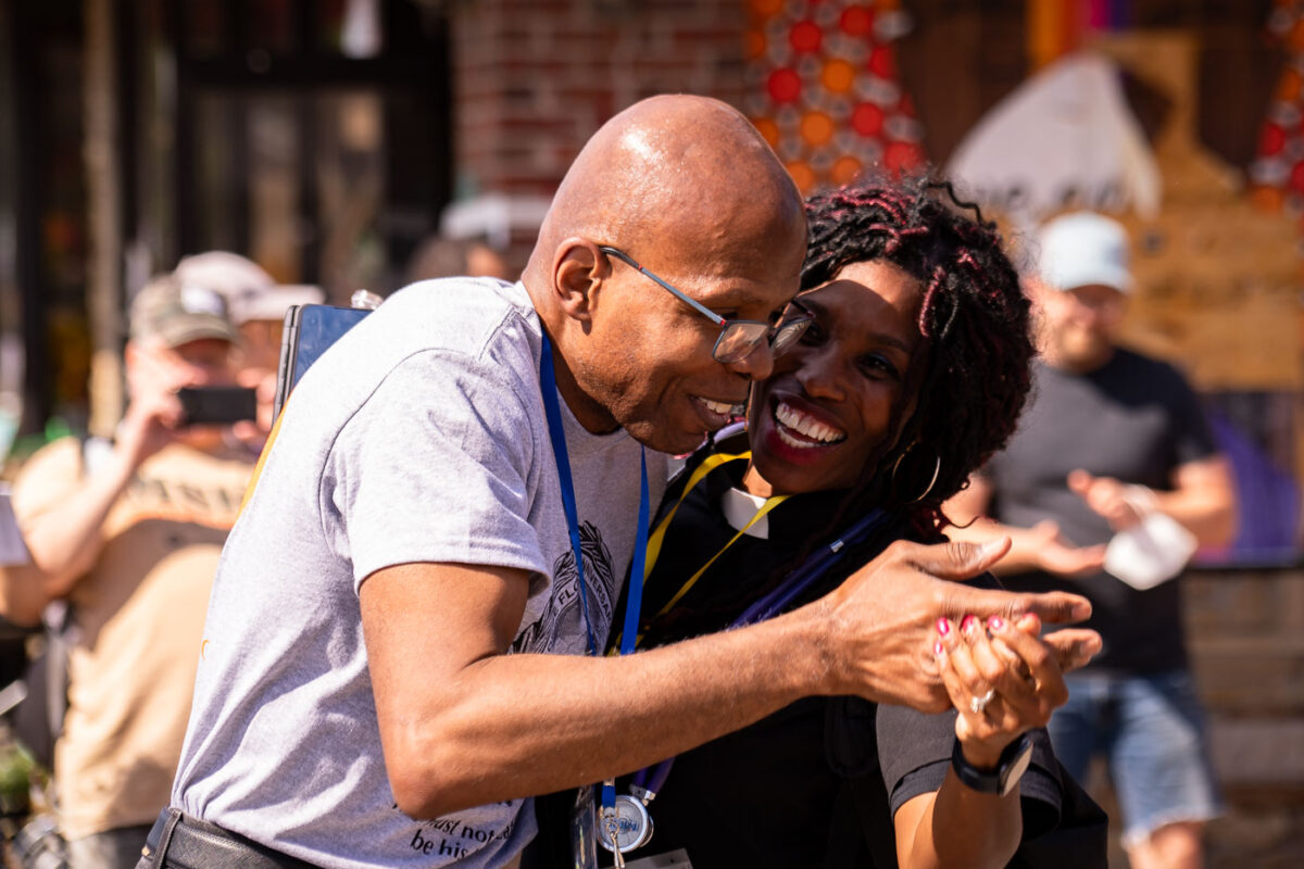 A community medic dances with one of George Floyd's family members on the 1-year anniversary of his murder.