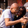 A community medic dances with one of George Floyd's family members on the 1-year anniversary of his murder.