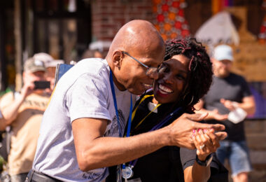 A community medic dances with one of George Floyd's family members on the 1-year anniversary of his murder.